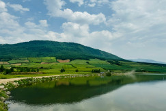 An illustrative photo of a lake in the green mountains. 