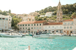 An illustrative photo of white boats near the port at daytime.