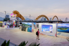 An illustrative photo of a person standing in front of a wall with pictures on it.