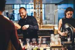 An illustrative photo of man and woman mixing beverages.
