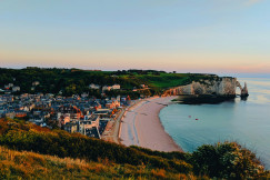 An illustrative photo of buildings on a coast near a body of water.