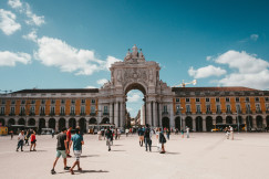 An illustrative photo of people walking on a square.