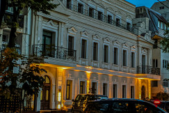 An illustrative photo of a city street with cars parked on the side of it.