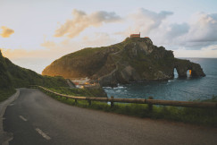 An illustrative photo of a road near a body of water.