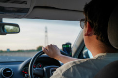 An illustrative photo of a man driving a car.