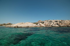 An illustrative photo of a body of water with rocks in the background.