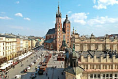 An illustrative photo of a view of a city square with a tower in the background.