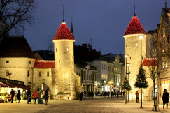 An illustrative photo of people walking near a castle during night time.