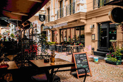 An illustrative photo of a street with cafes. 
