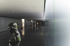 An illustrative photo of people walking in a museum with statues.