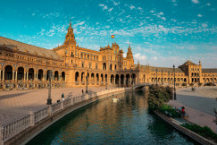 An illustrative photo of a big beige building near a river.