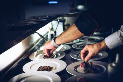 An illustrative photo of a chef preparing dishes.