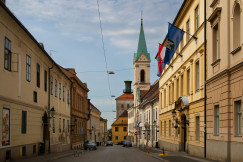 An illustrative photo of a street with beige buildings.