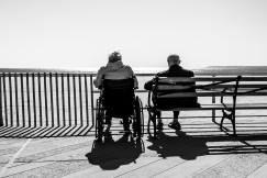 An illustrative photo of a couple sitting on the bench.