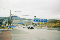 An illustrative photo of cars travel down a road.