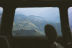 An illustrative photo of a view of mountains from inside a vehicle.