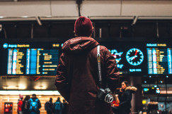 An illustrative photo of a person looking up to the flight schedules.