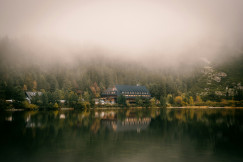 An illustrative photo of a lake with a house.