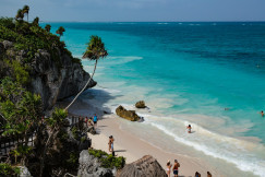 An illustrative photo of people walking along the coast.