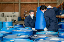 Workers holding barrels