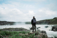 Man near waterfall