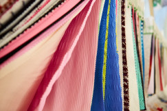 Picture shows layers of fabric in different colours - pink, blue and green