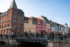 people-walking-on-bridge-near-buildings-during-daytime