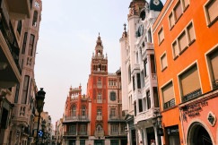 colorful-buildings-line-a-european-street-with-a-tower