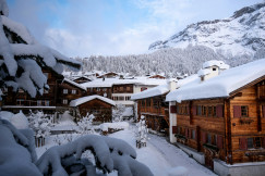 Brown wooden houses in the snowy mountain valley