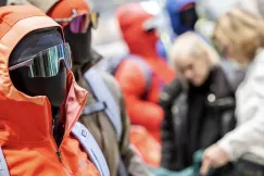 Dummy wearing orange jacket and sporty sunglasses 