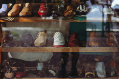 A display case filled with lots of different types of shoes. 