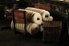 several rolls of yarn on a wooden chair