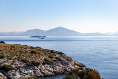 a-view-of-a-body-of-water-with-mountains-in-the-background