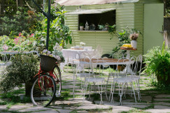 a-bicycle-is-parked-in-front-of-a-table-and-chairs