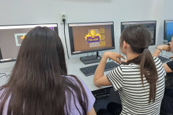 Two students playing a videogame on the computer.