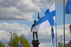 a-statue-of-a-person-holding-a-cross-and-a-flag