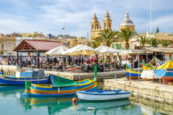 blue-and-yellow-boat-on-water-near-brown-concrete-building-during-daytime