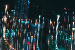Blurred city lights at night with long exposure light trails representing digital data movement