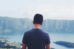 man-standing-outdoors-with-body-of-water-at-distance-during-daytime