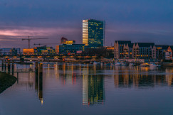 a-body-of-water-with-a-city-in-the-background