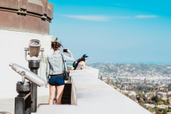 woman-standing-on-terrace-facing-city
