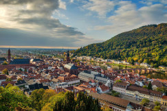 aerial-view-of-city-buildings-near-green-mountain-during-daytime