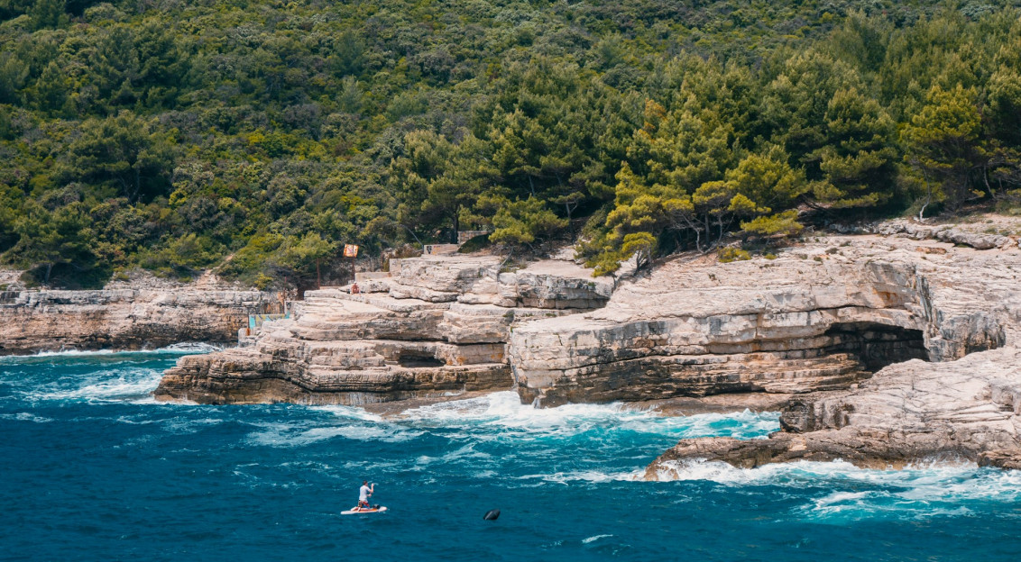 crystal-blue-sea-beside-rock-formation