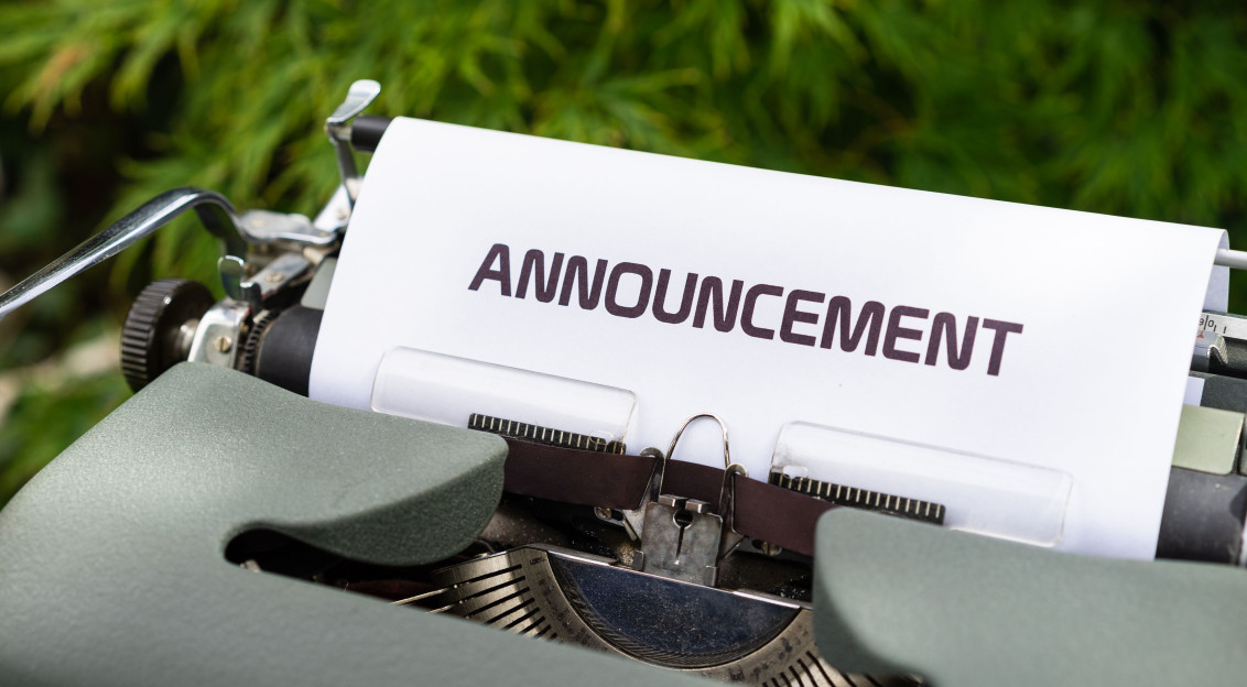 Close-up of a paper labeled 'Announcement' in a typewriter outdoors.
