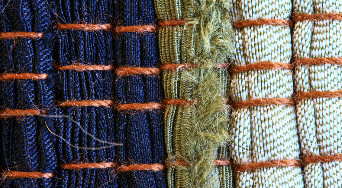 Close-up of woven textile samples in different colours and textures, representing textile materials, circular design and sustainable innovation in the textile industry.