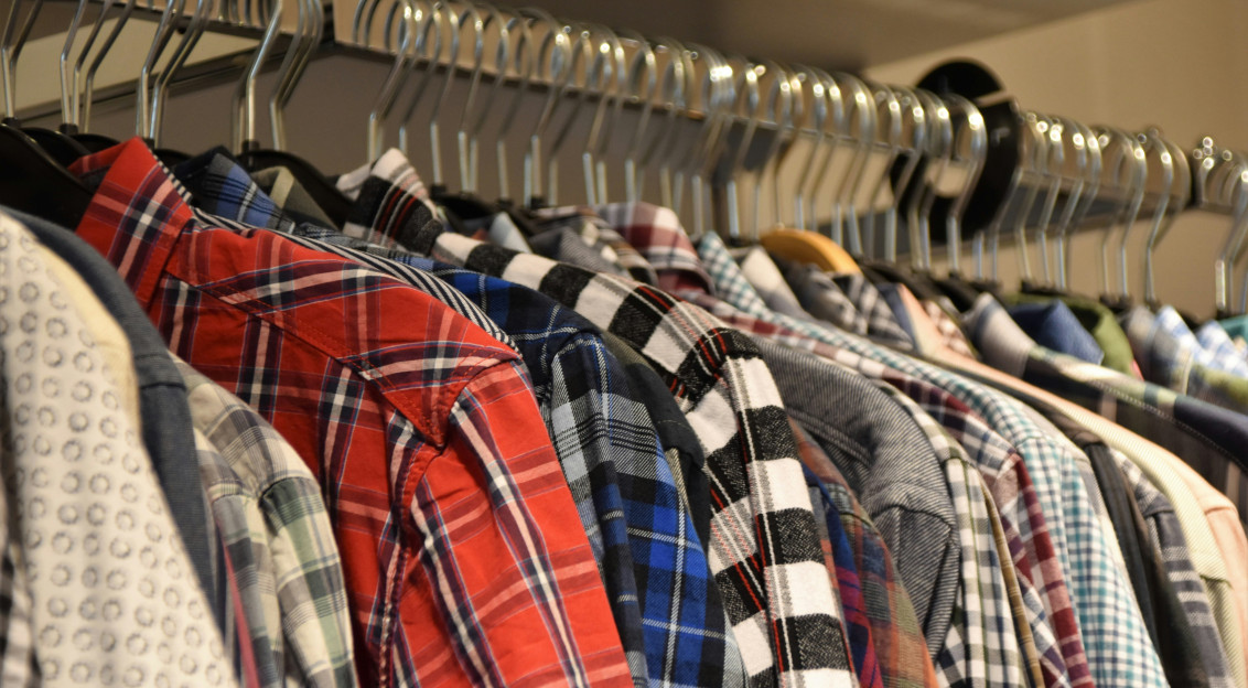 Colourful patterned shirts displayed on clothing racks, representing textile products, fabrics and retail sourcing.