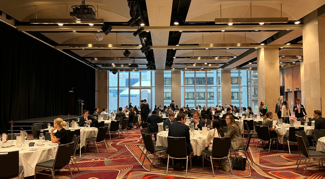 A group of people sitting at tables.