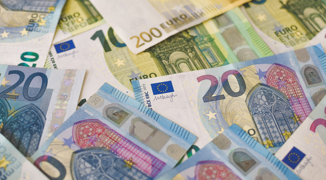 The photo presents a collection of euro banknotes.