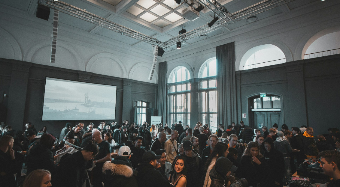 The photo presents a crowded indoor event.