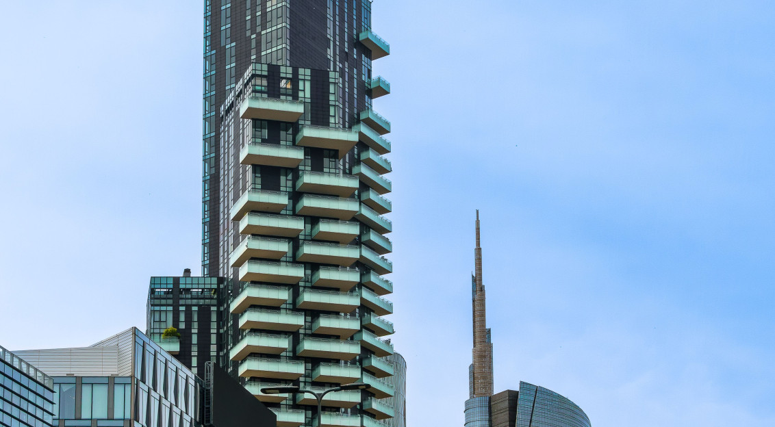 The picture shows a modern urban district in Milan, Italy, characterized by contemporary high-rise architecture and extensive glass façades.